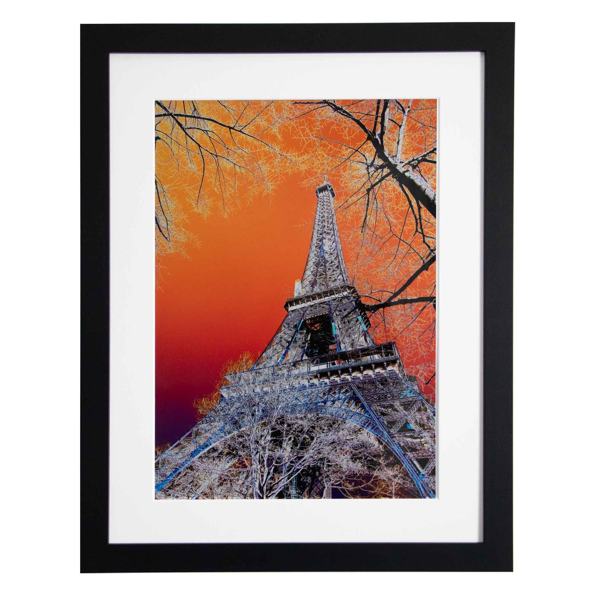 Framed artwork of the Eiffel Tower against an orange sky with tree from Ximago