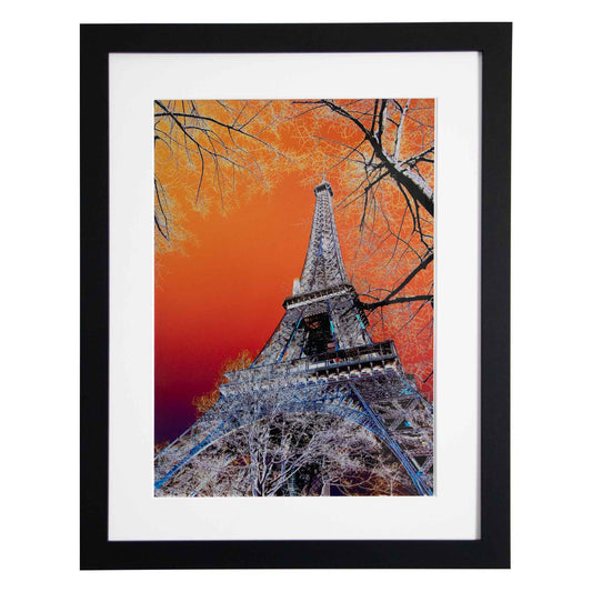 Framed artwork of the Eiffel Tower against an orange sky with tree from Ximago